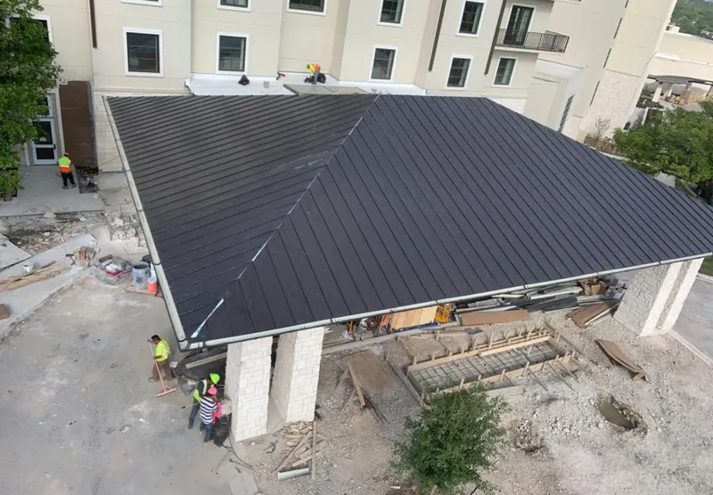 Metal roofing installation team working on a commercial building in Fort Hunt